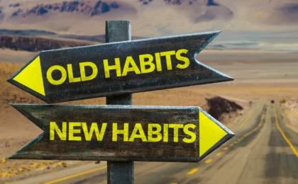 Two signs with Old Habits pointing to the left and New Habits to the right